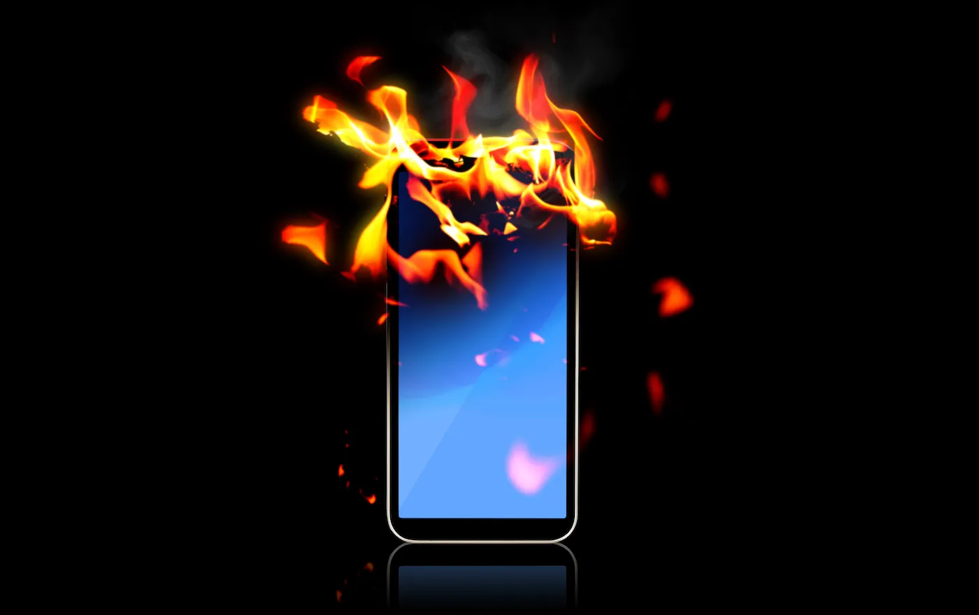 A burning smartphone against a black background