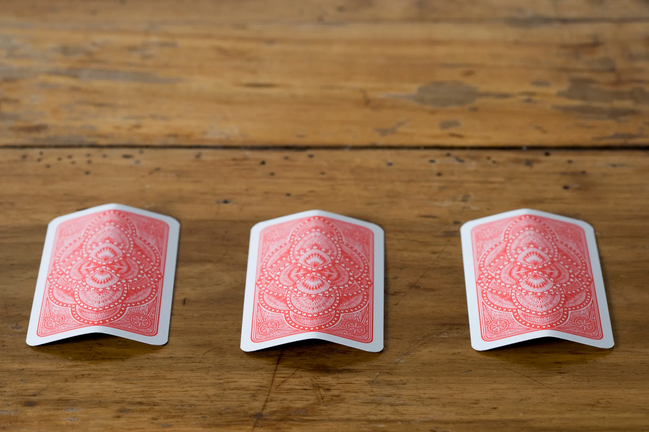 three cards face down on a table