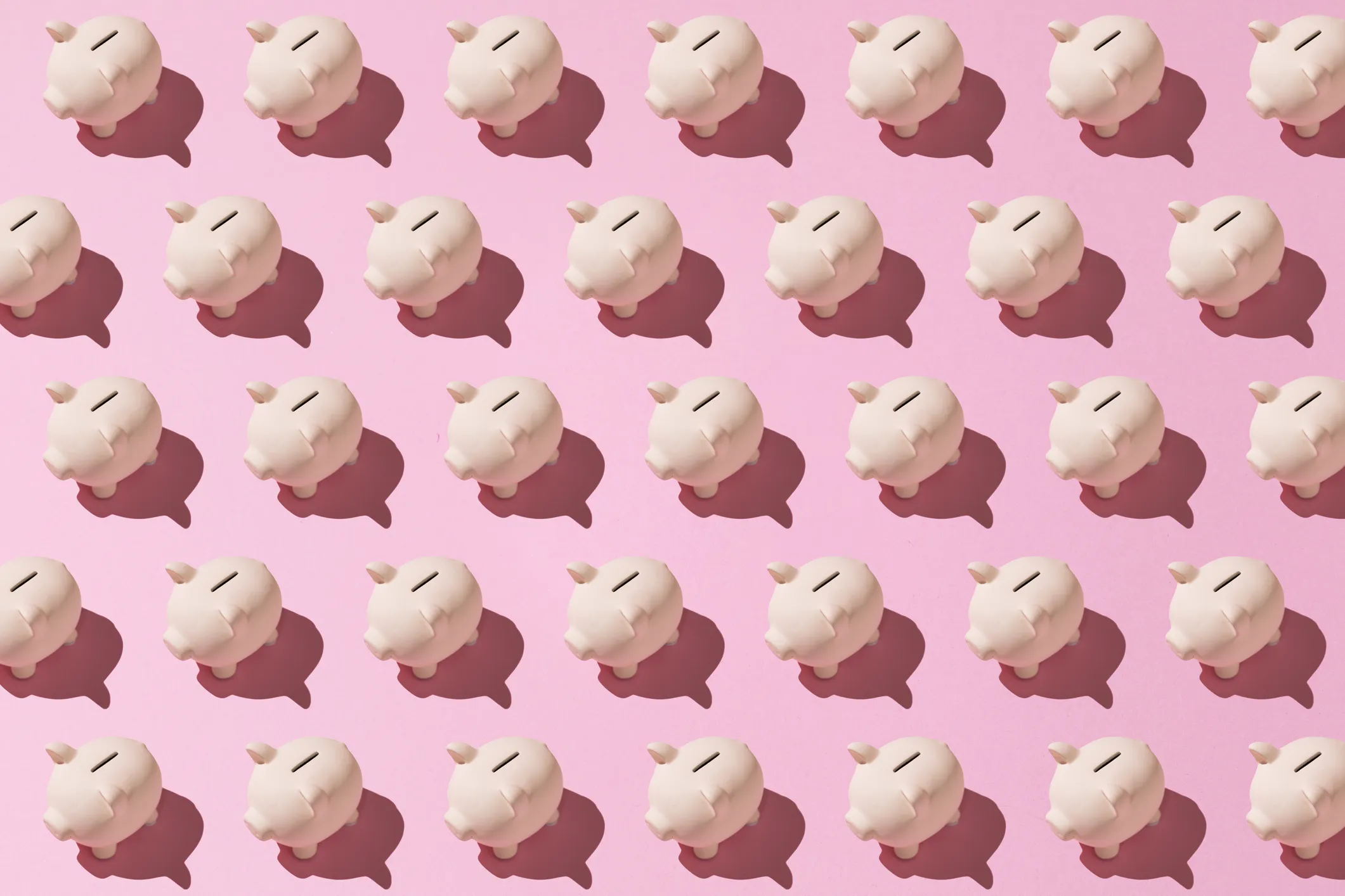 Little pink ceramic piggy bank pattern on pink background. Concept of saving money, savings.