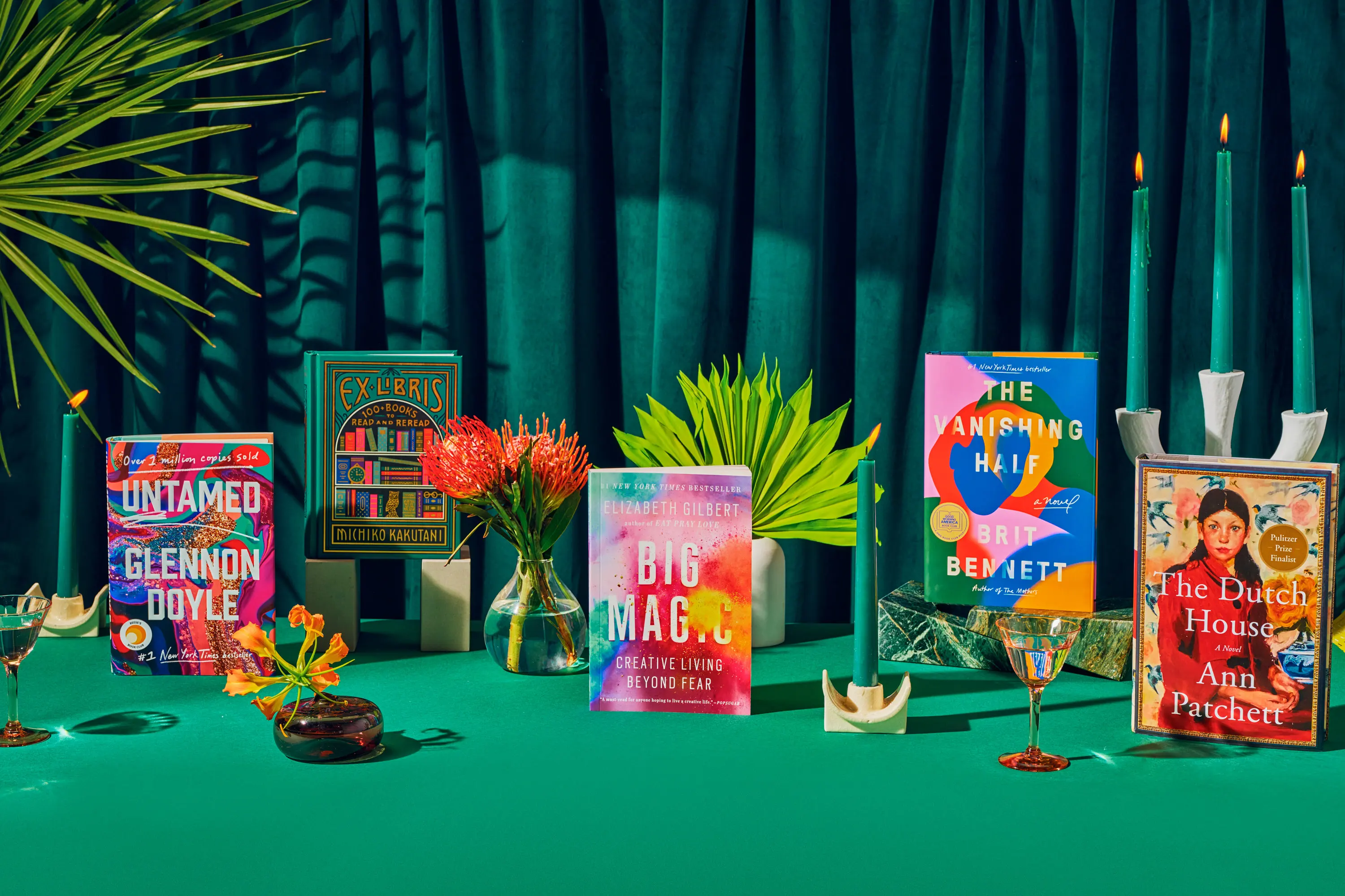 Books arranged on a decorative green background