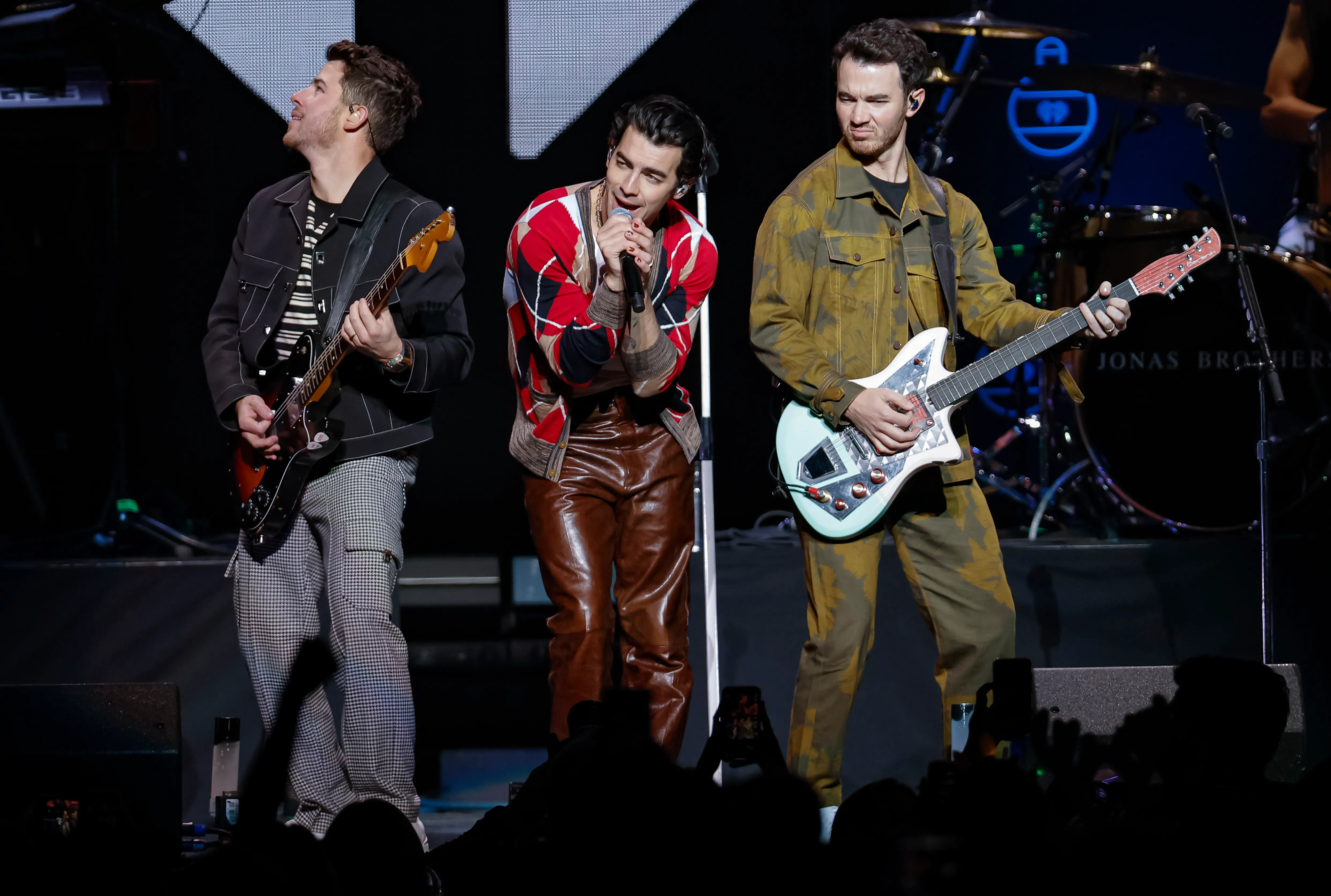 Image of Nick Jonas, Joe Jonas, and Kevin Jonas of Jonas Brothers perform during the Jingle Ball at Capital One Arena on December 14, 2021, in Washington, D.C.