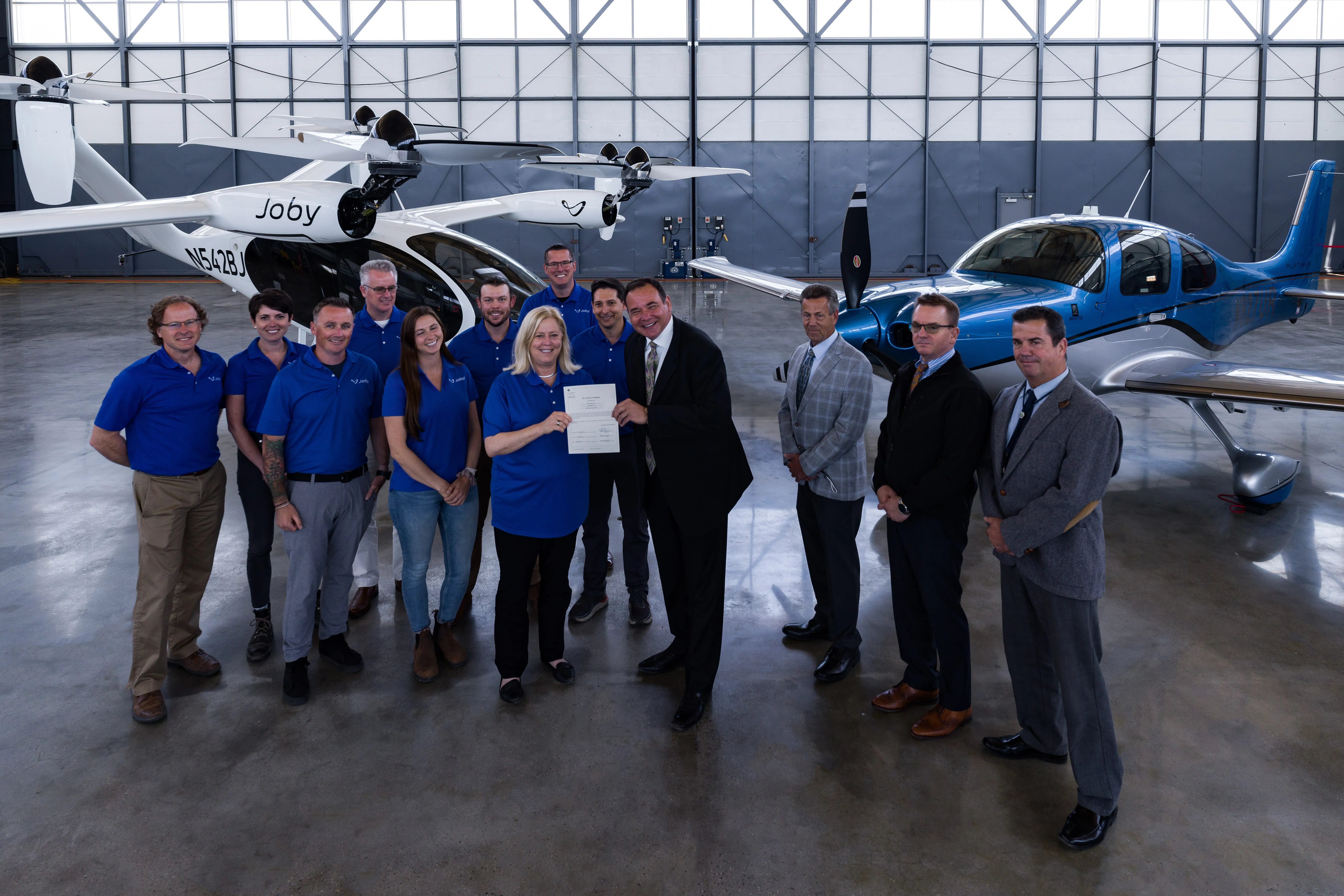 Joby Aviation crew in hangar in front of eVTOLs