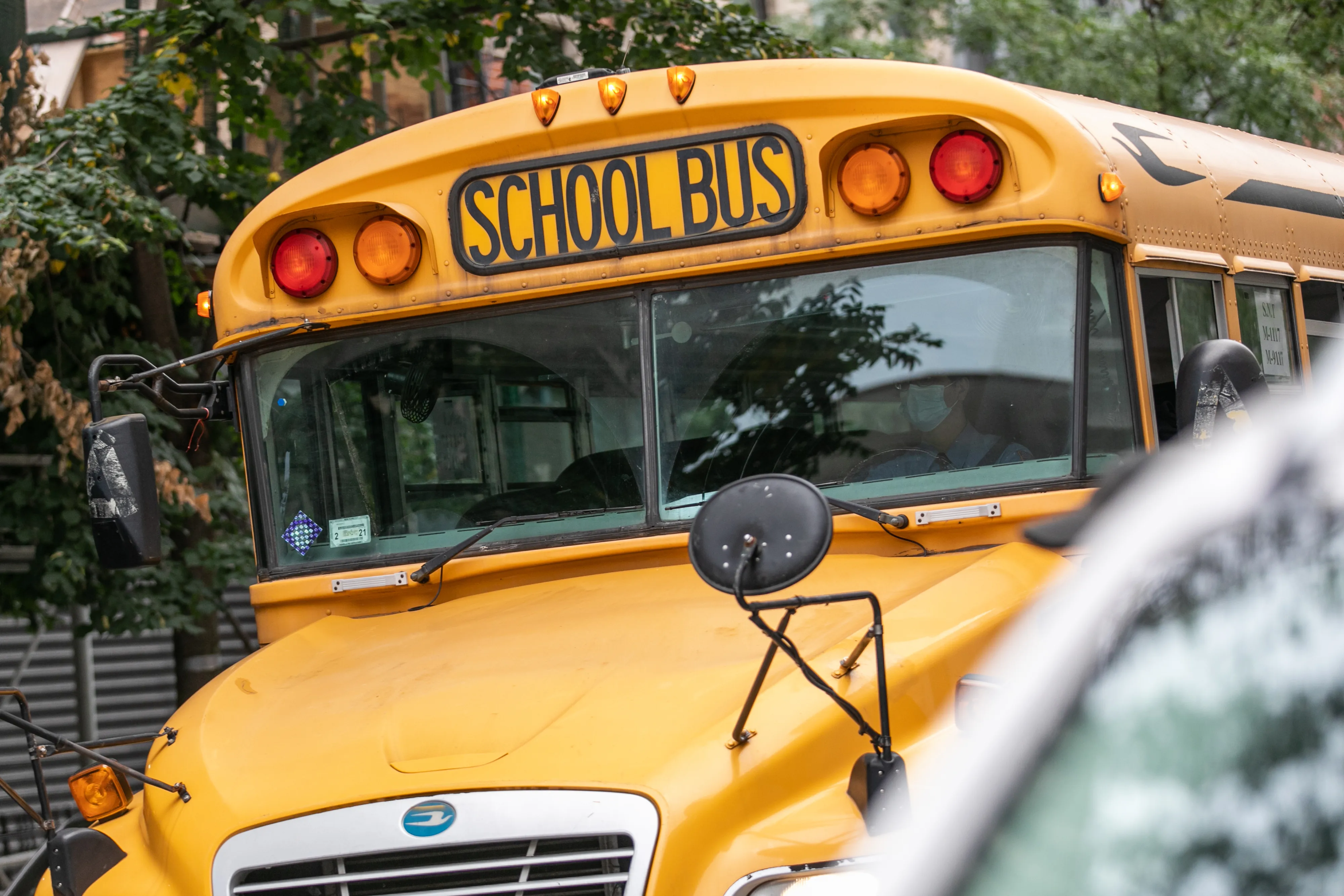 A school bus moves along a street in New York
