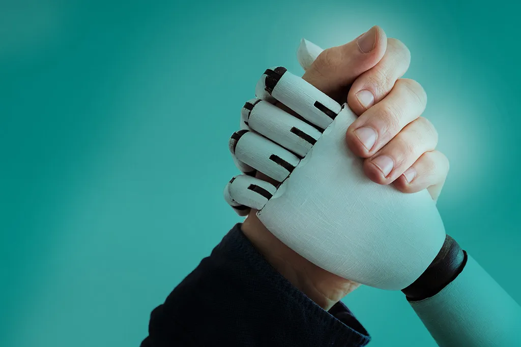 human hand an robot hand clasped for arm wrestling