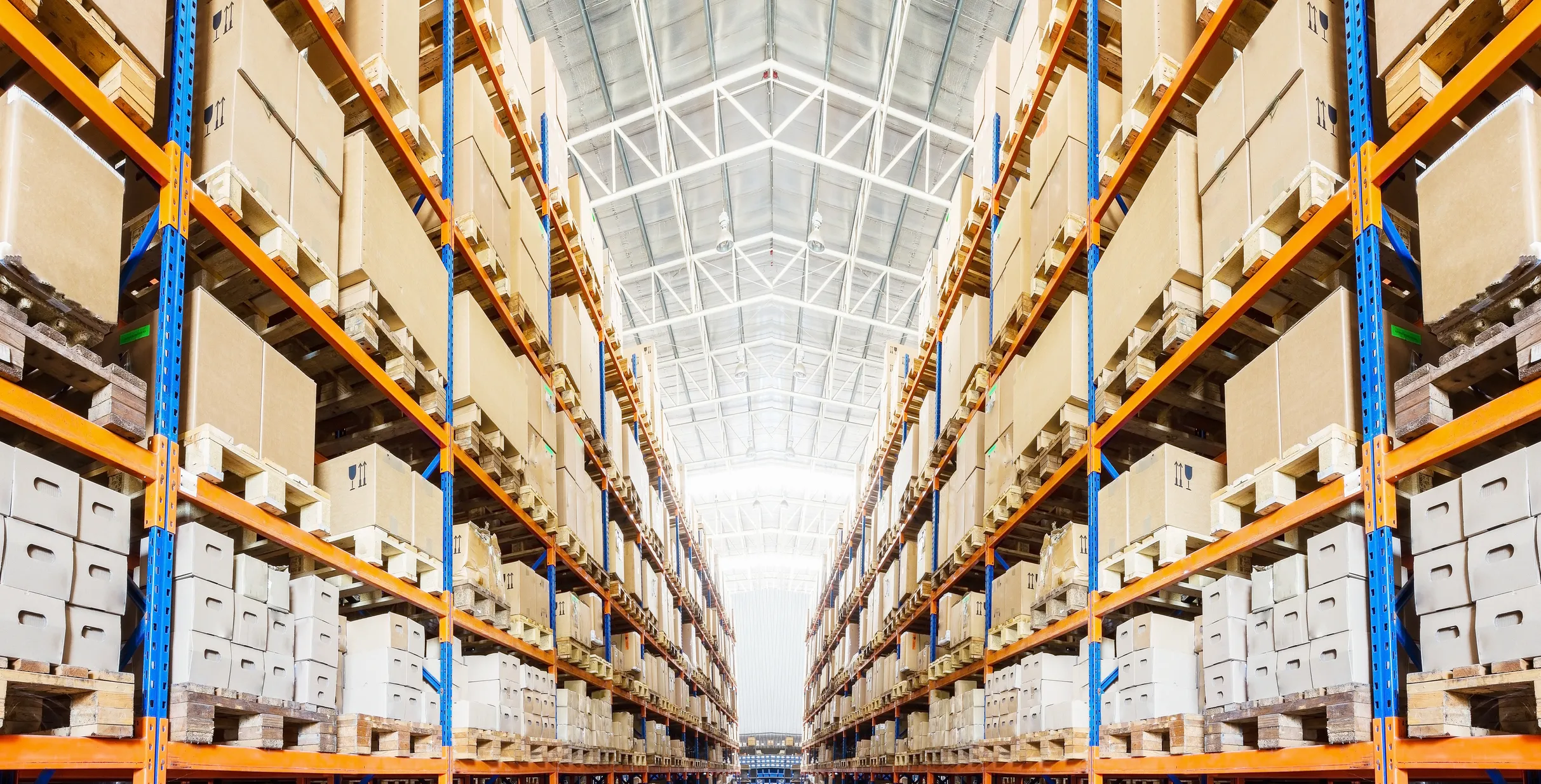Rows of shelves with boxes in modern warehouse
