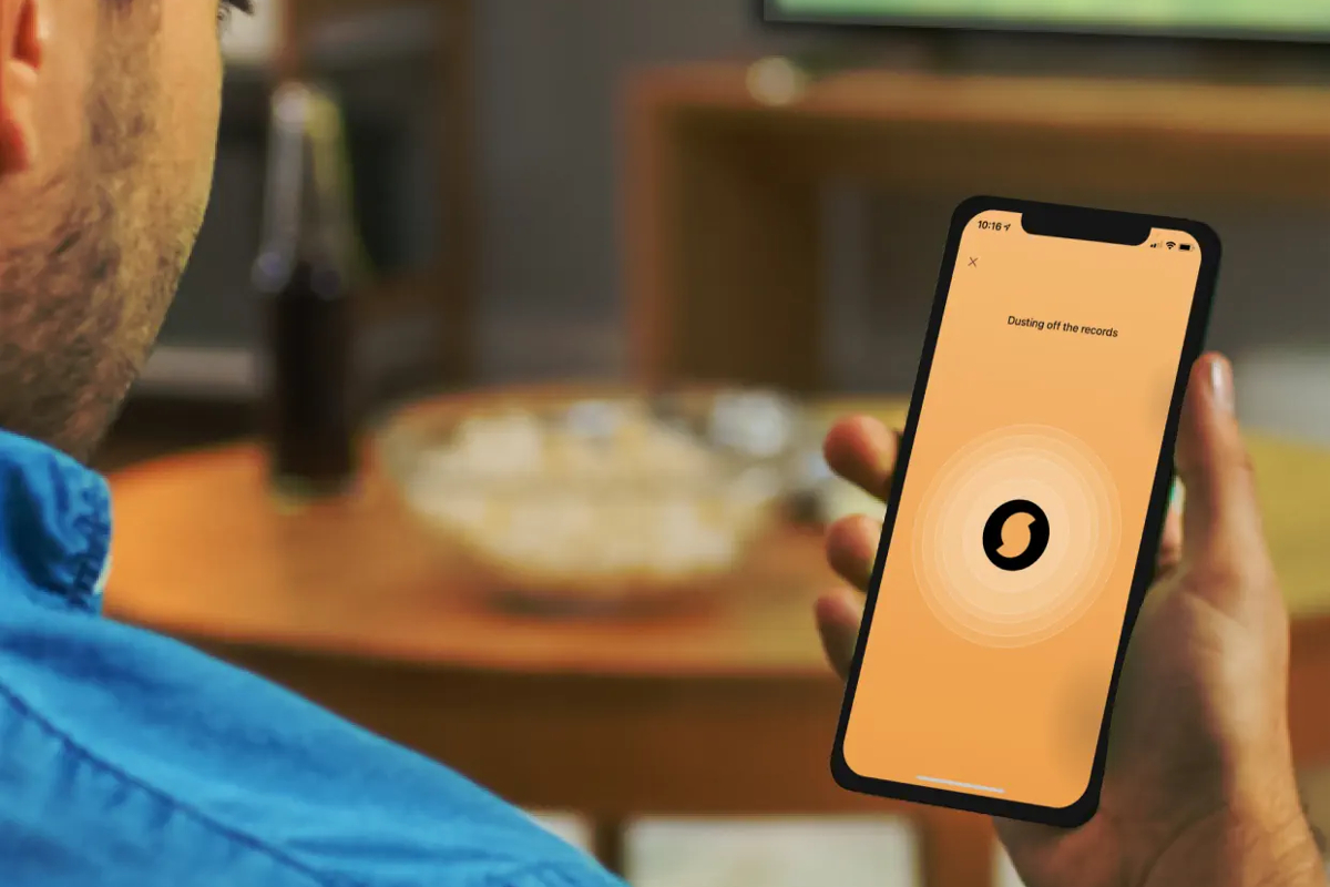 Man lokking at SoundHound app on smartphone