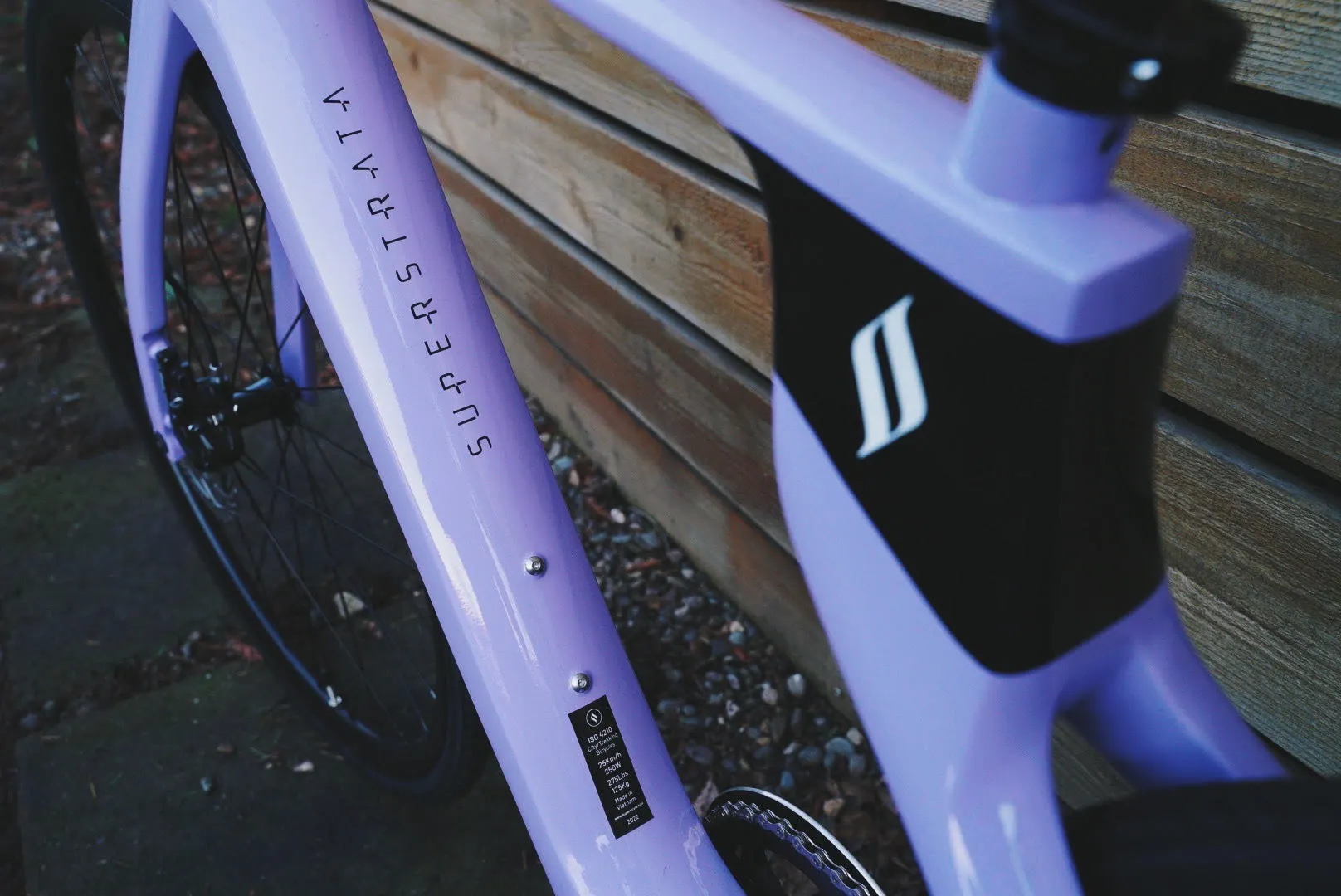 Close up photo of Superstrata e-bike carbon fiber unibody frame in a glossy lavender color