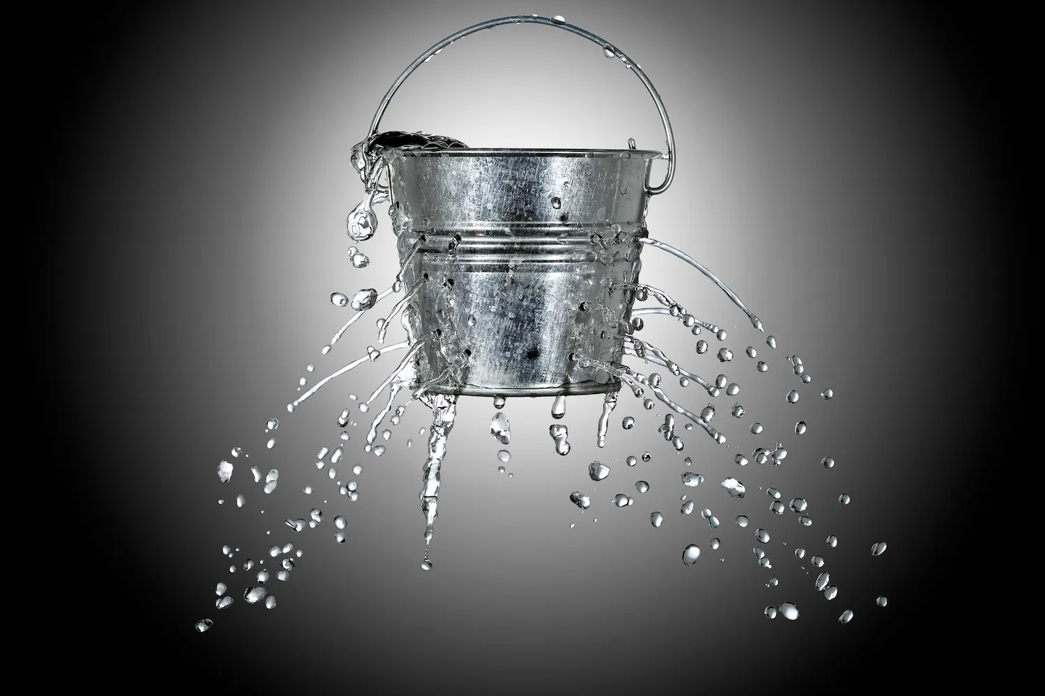 water is coming out of a bucket with holes