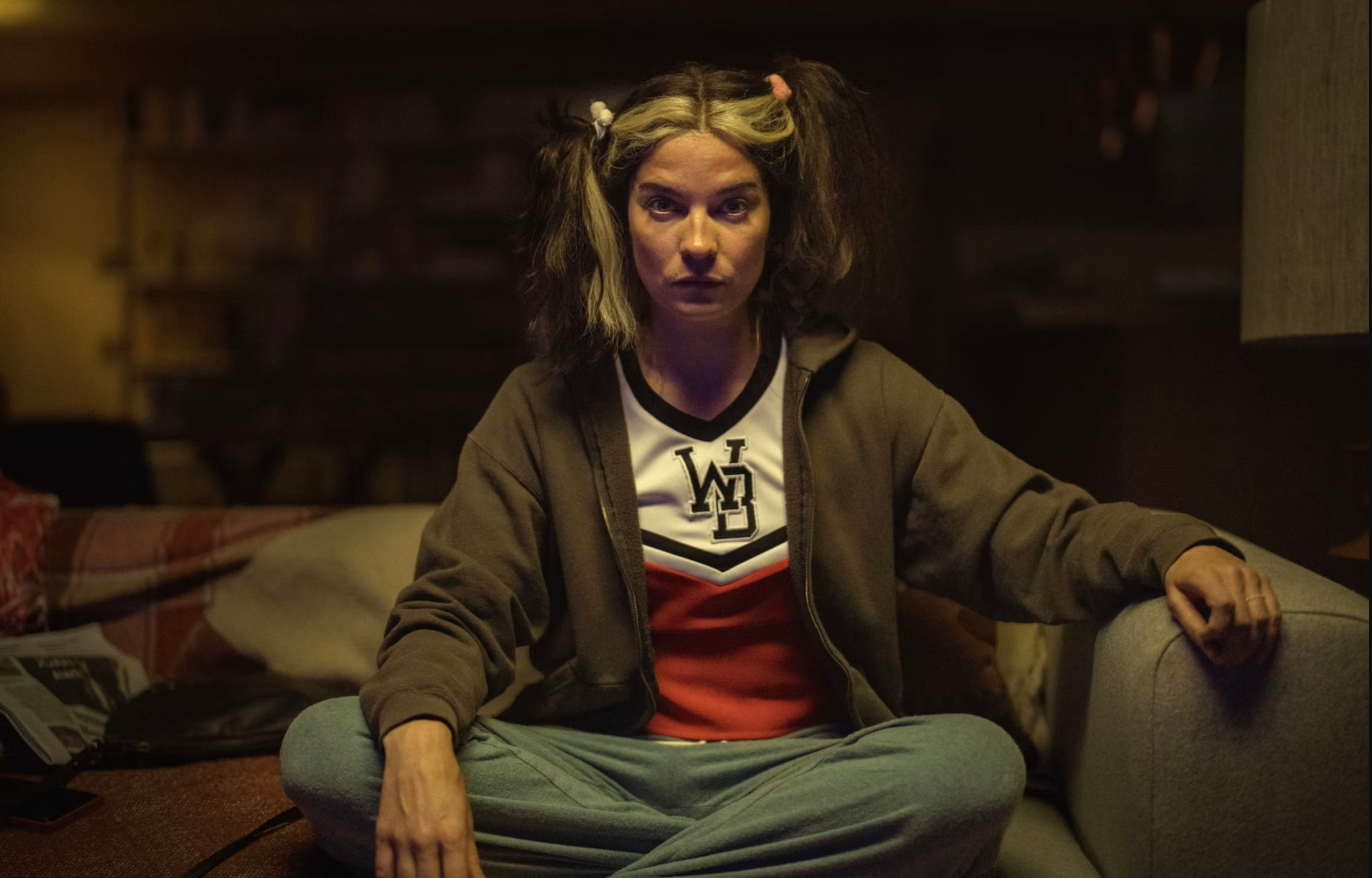 Woman sitting cross-legged on a couch; scene from Black Mirror