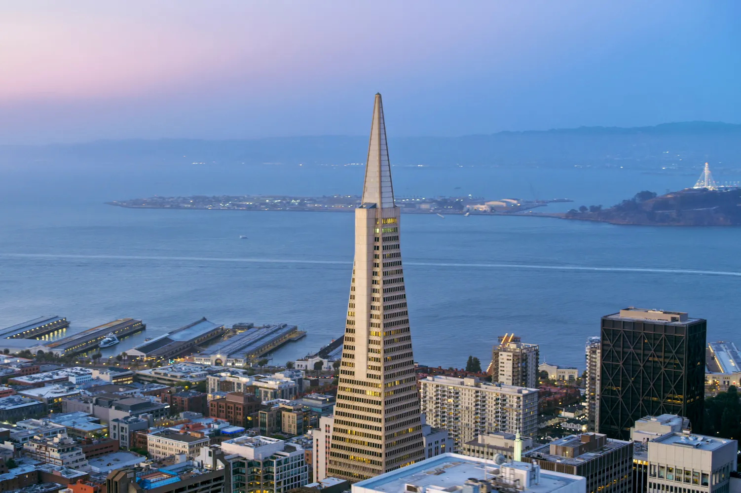 Aerial shot of the Downtown San Francisco and San Francisco Bay in the background in the evening. Shot in California, USA.