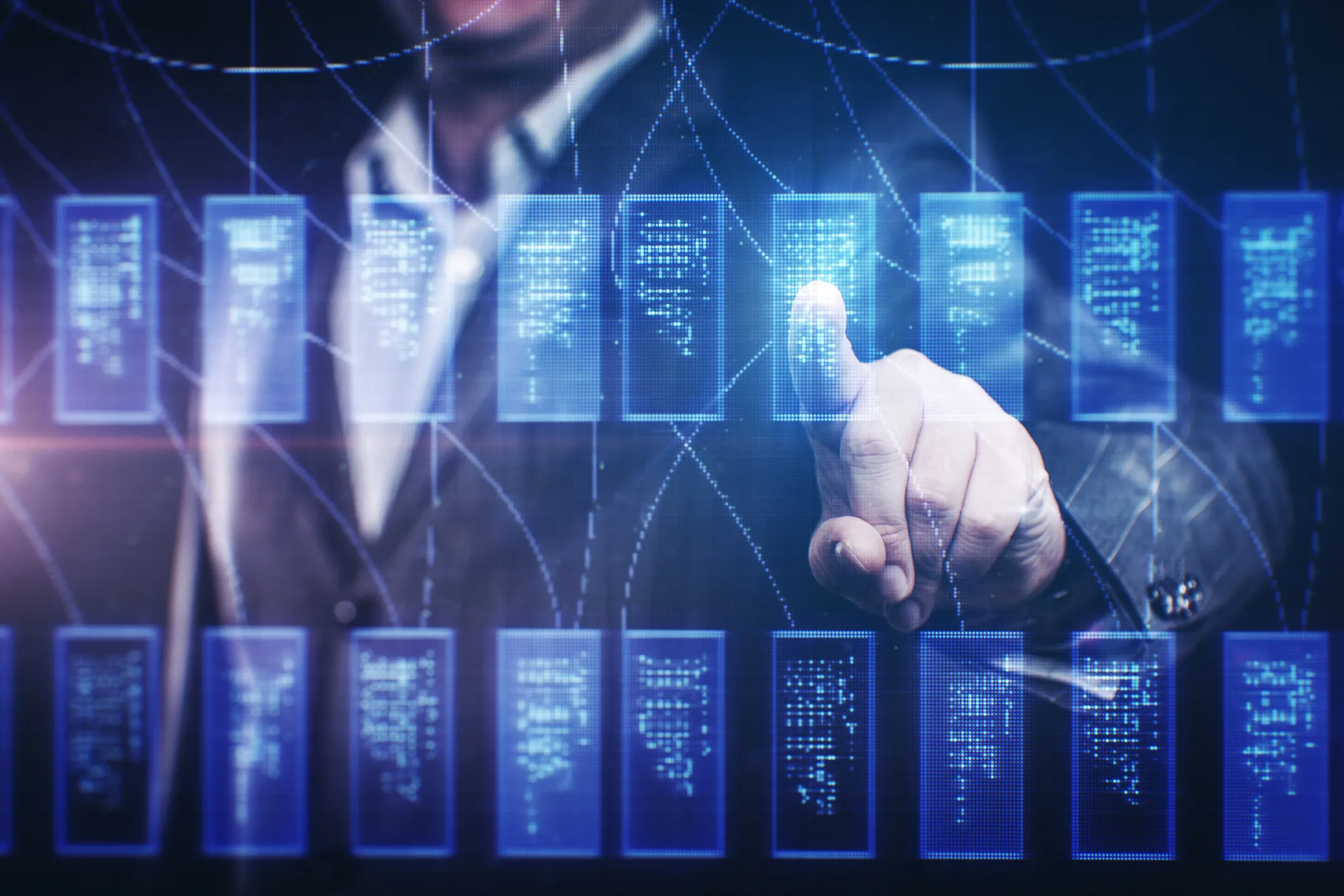 Man standing in front multiple connected data sources with blue tint.