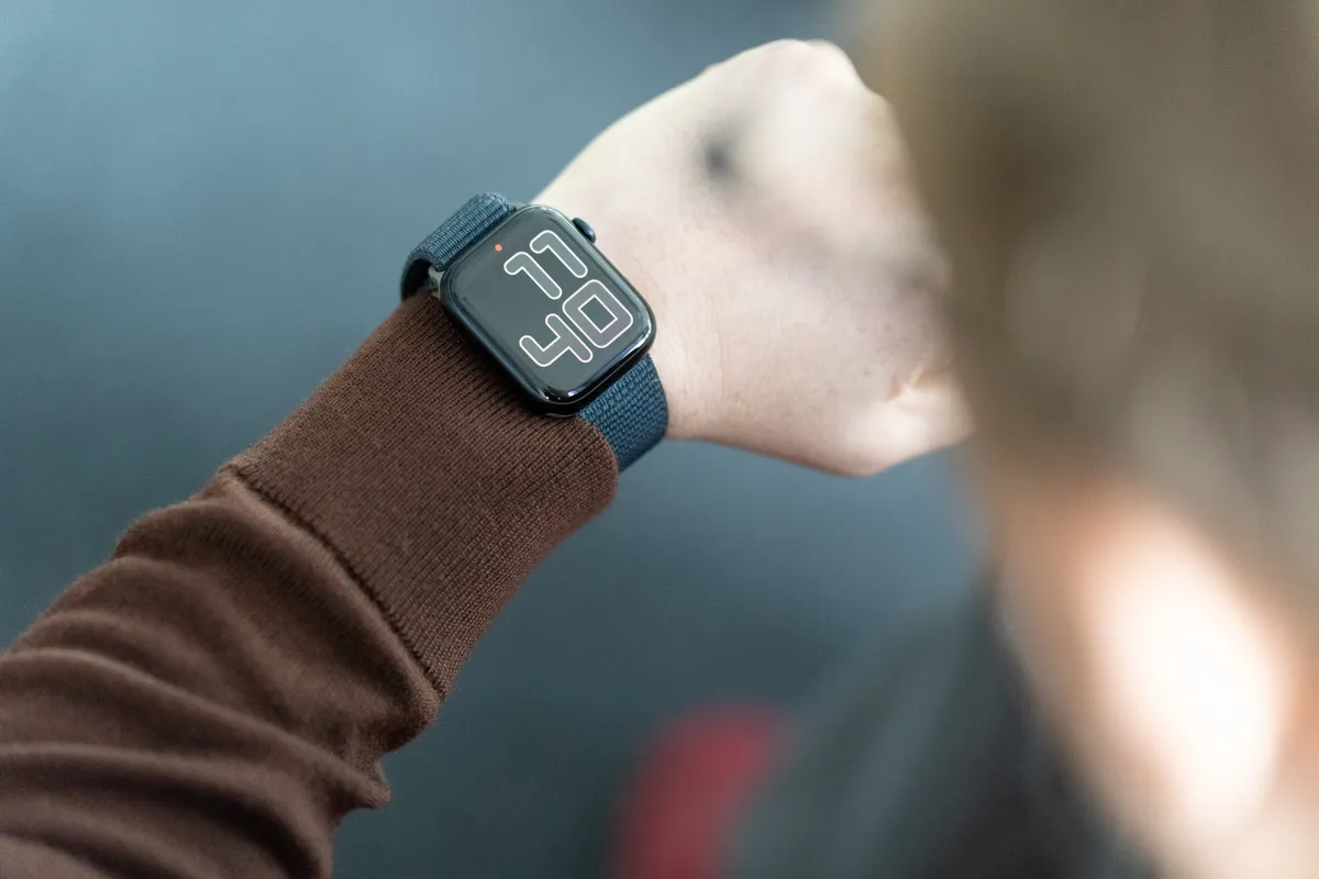 Apple Watch Series 9 on a wrist, with a watch face showing '11:40'