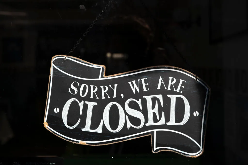 A closed sign in the window of a small business