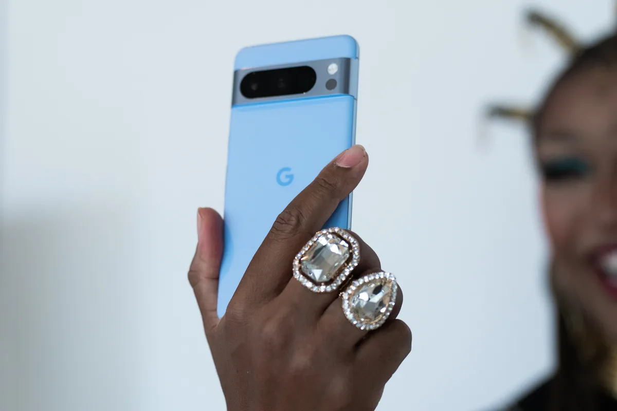 Google Pixel 8 Pro in Bay, being held aloft with the back facing the camera