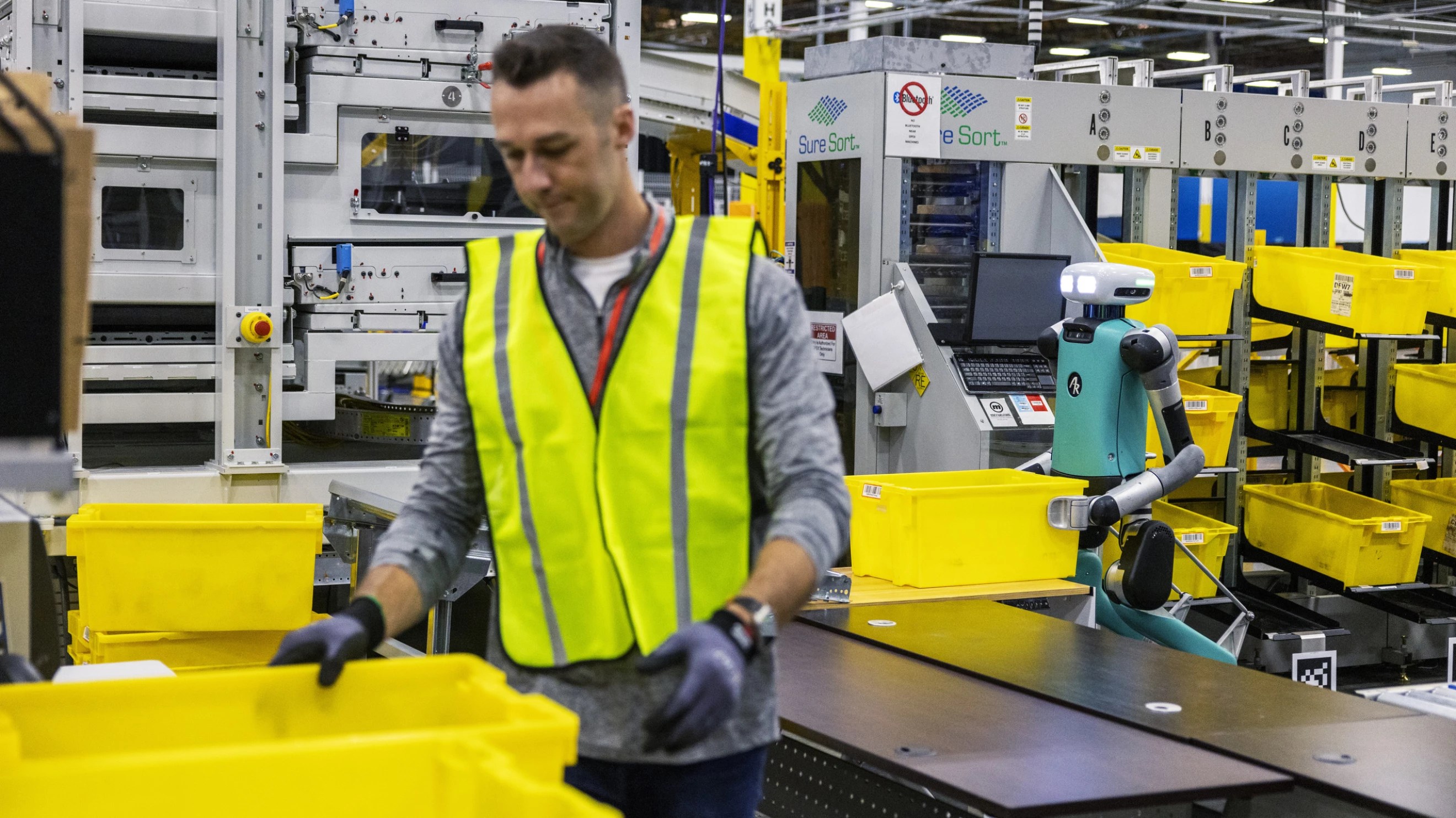 An Amazon worker alongside Agility Robotics' Digit robot