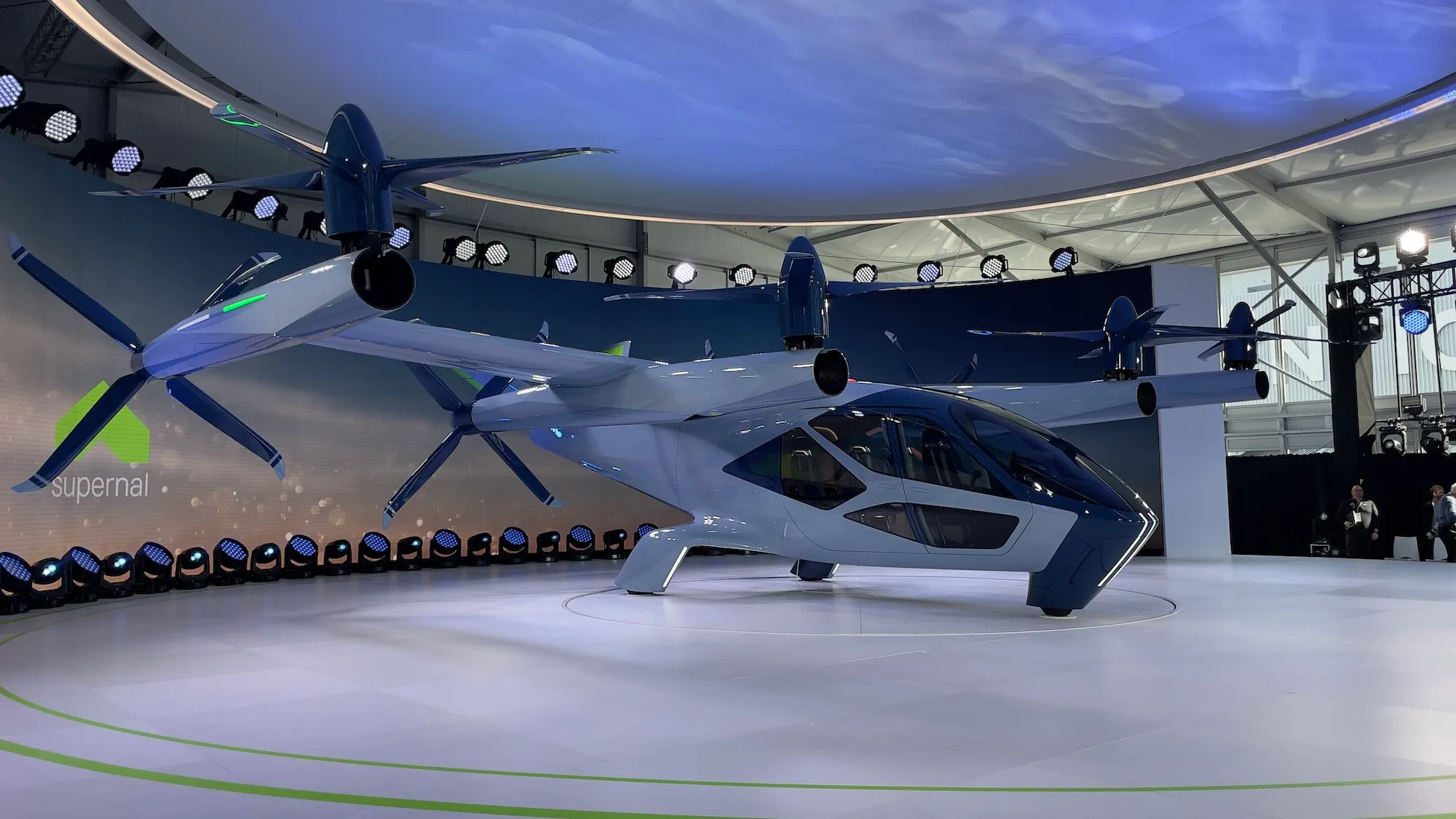an electric air taxi paint in white sits on a platform at CES 2024