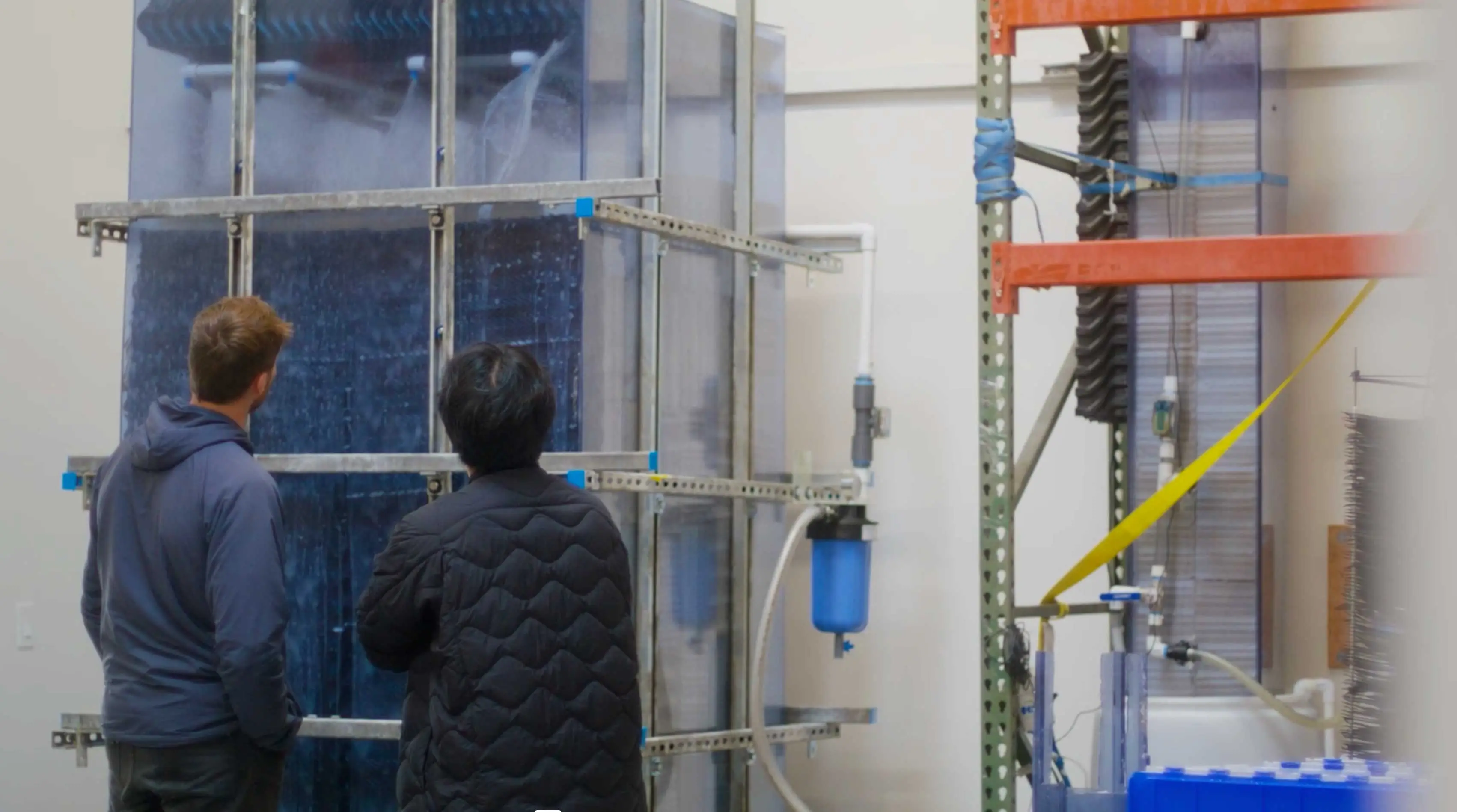 AirMyne employees inspect a direct air capture prototype.
