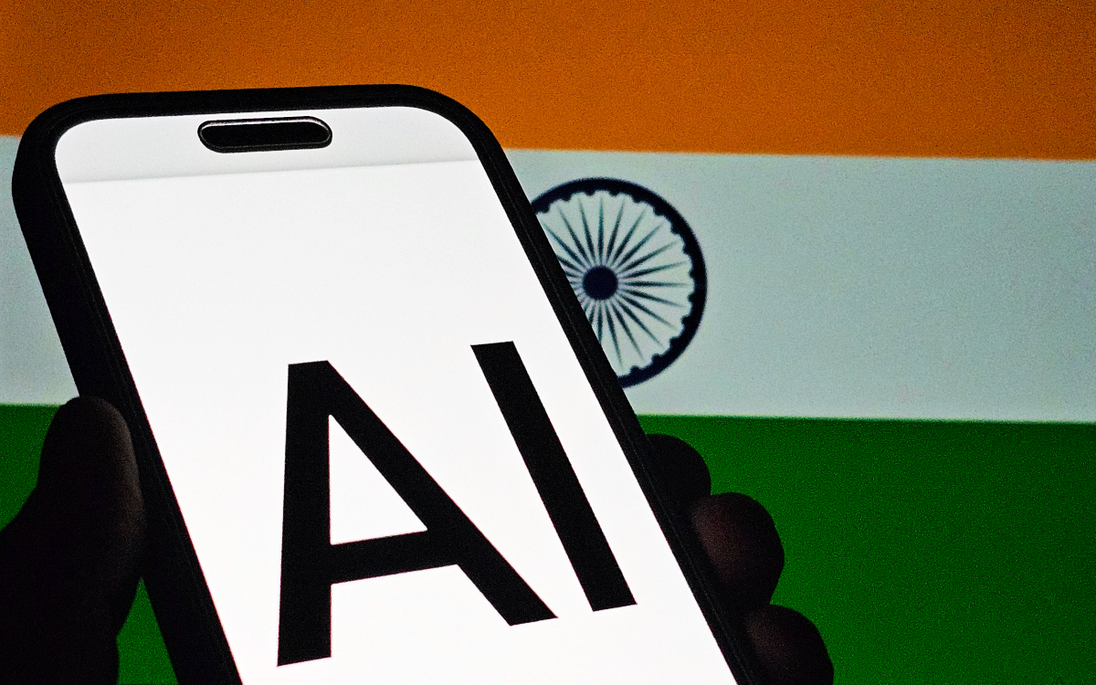 India flag with 'AI' displayed on smartphone screen in foreground