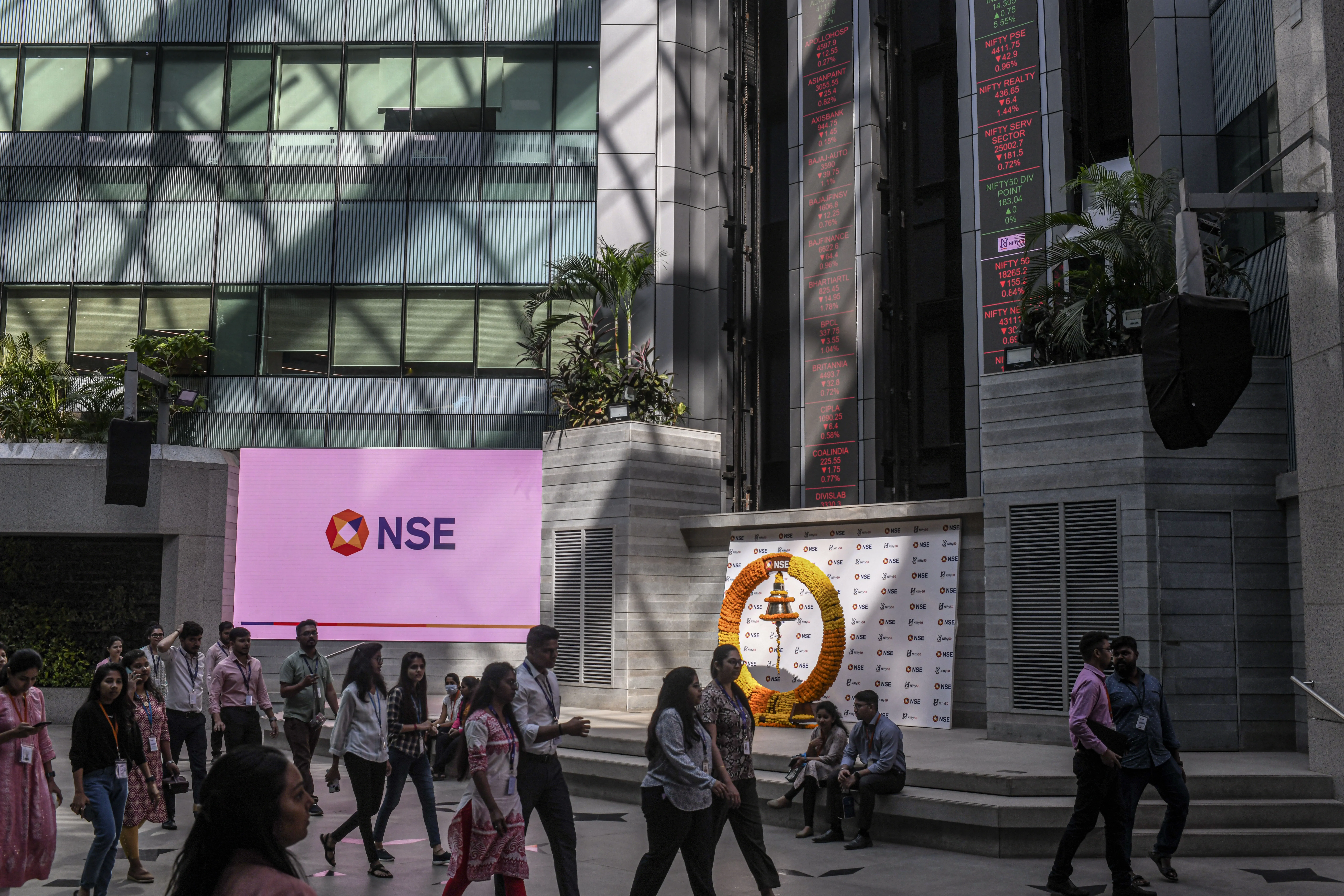 people walking past NSE sign