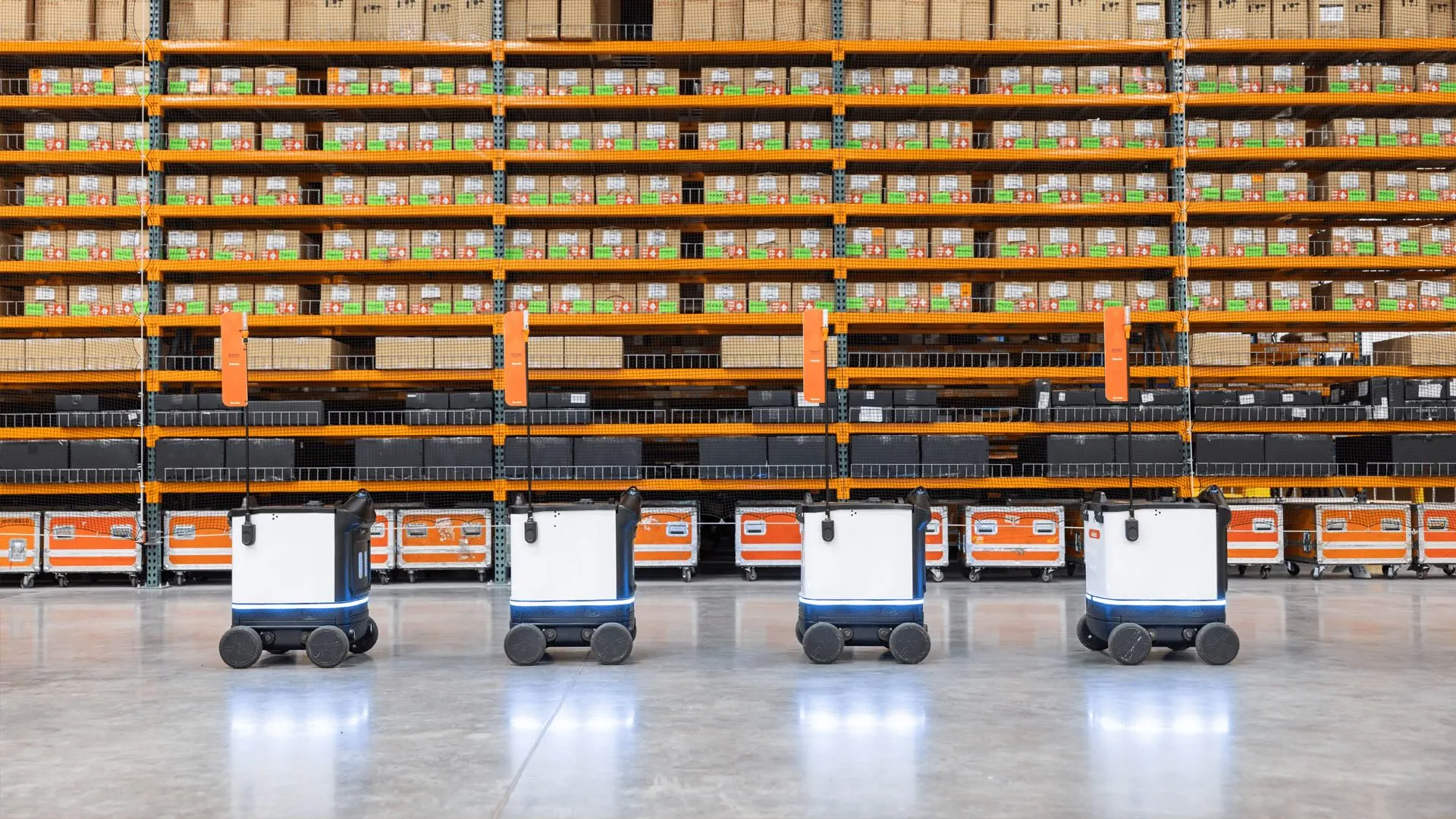 4 Kiwibots lined up in warehouse