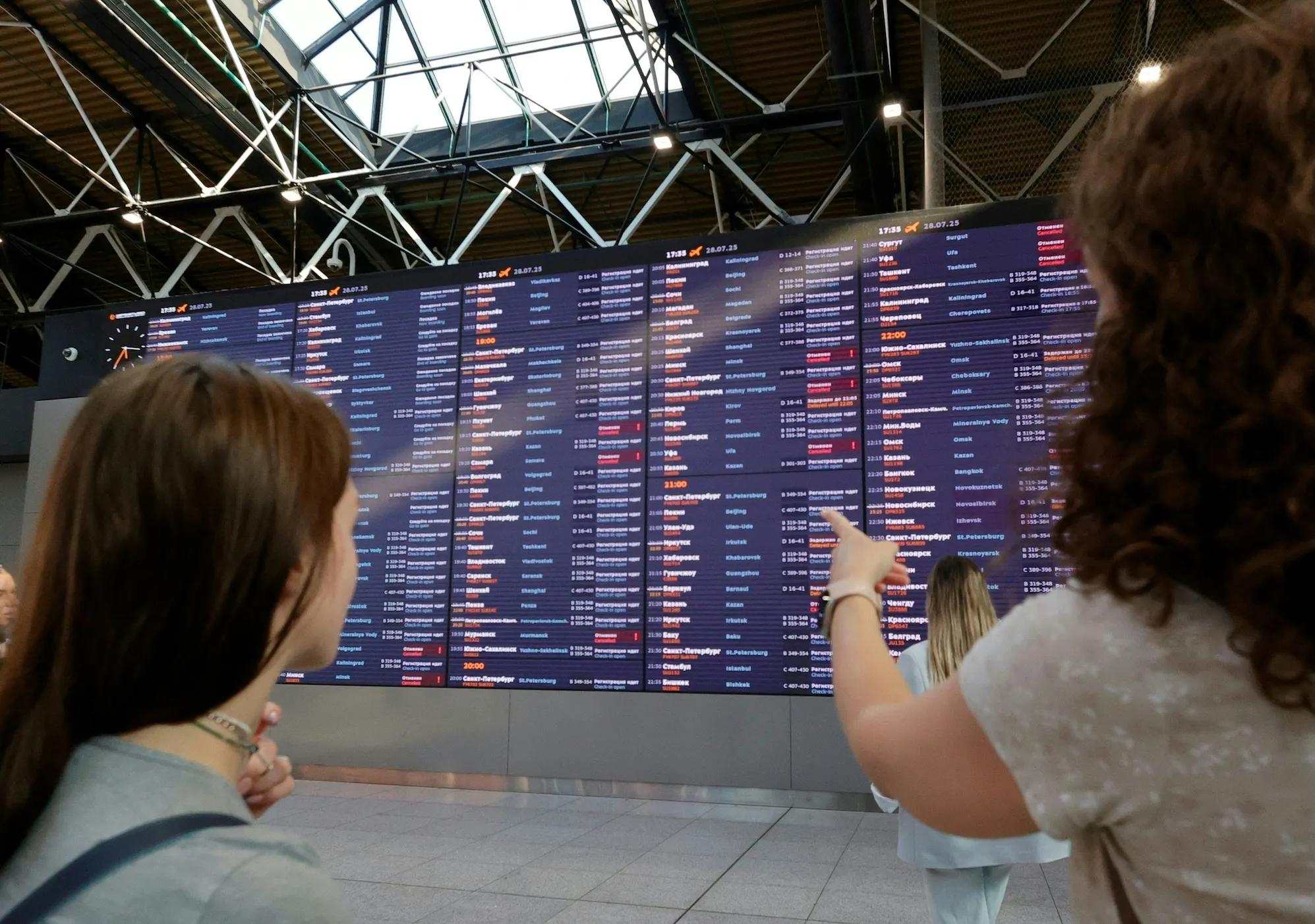 People wait for their flights at the Sheremetyevo International Airport on the outskirts of Moscow on July 28, 2025. A cyberattack on Russia's national airline Aeroflot grounded 42 flights on July 28, officials said, with a Ukrainian and a Belarusian hacker group claiming responsibility for the incident.