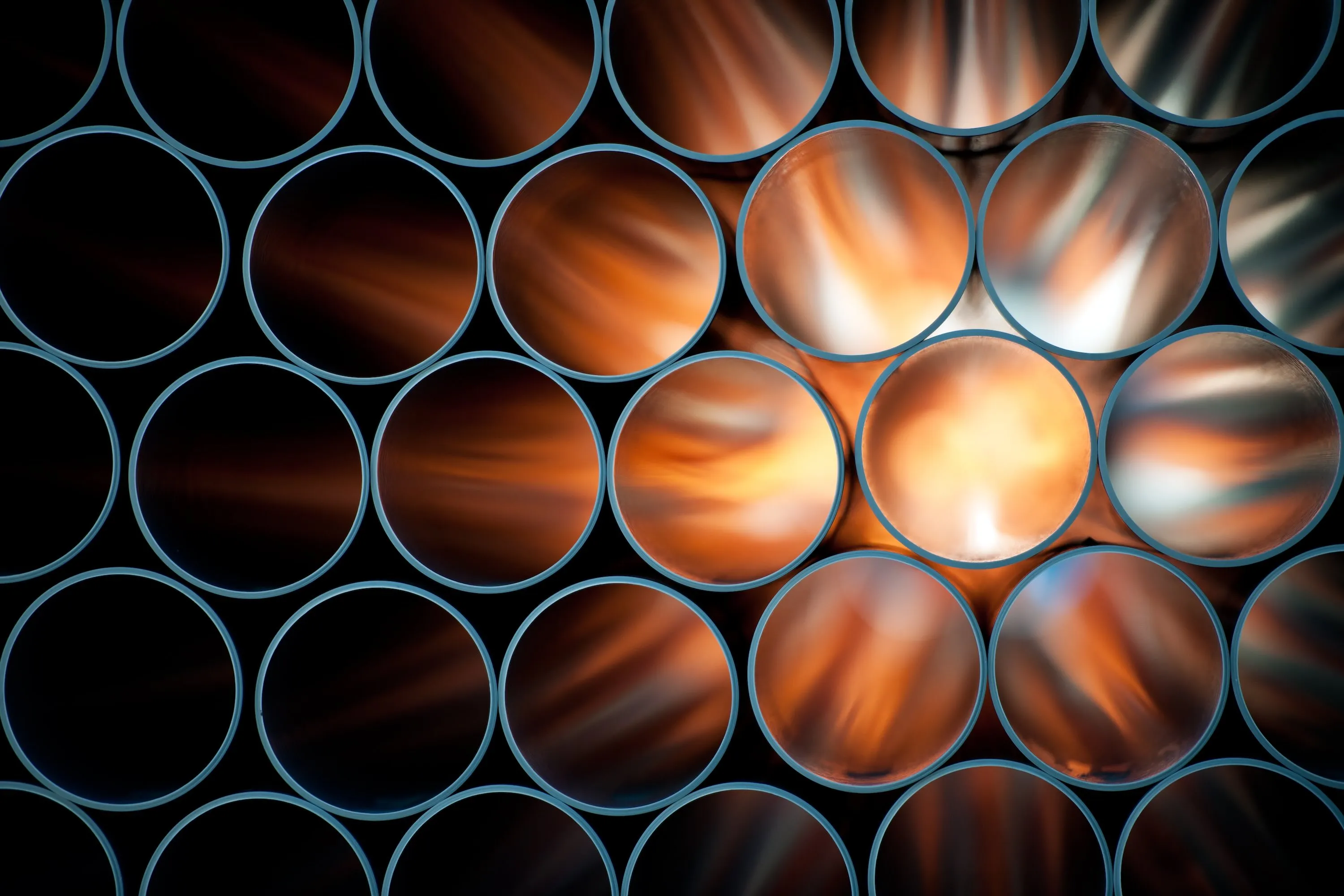 Pipes are backlit, causing them to appear to glow orange.