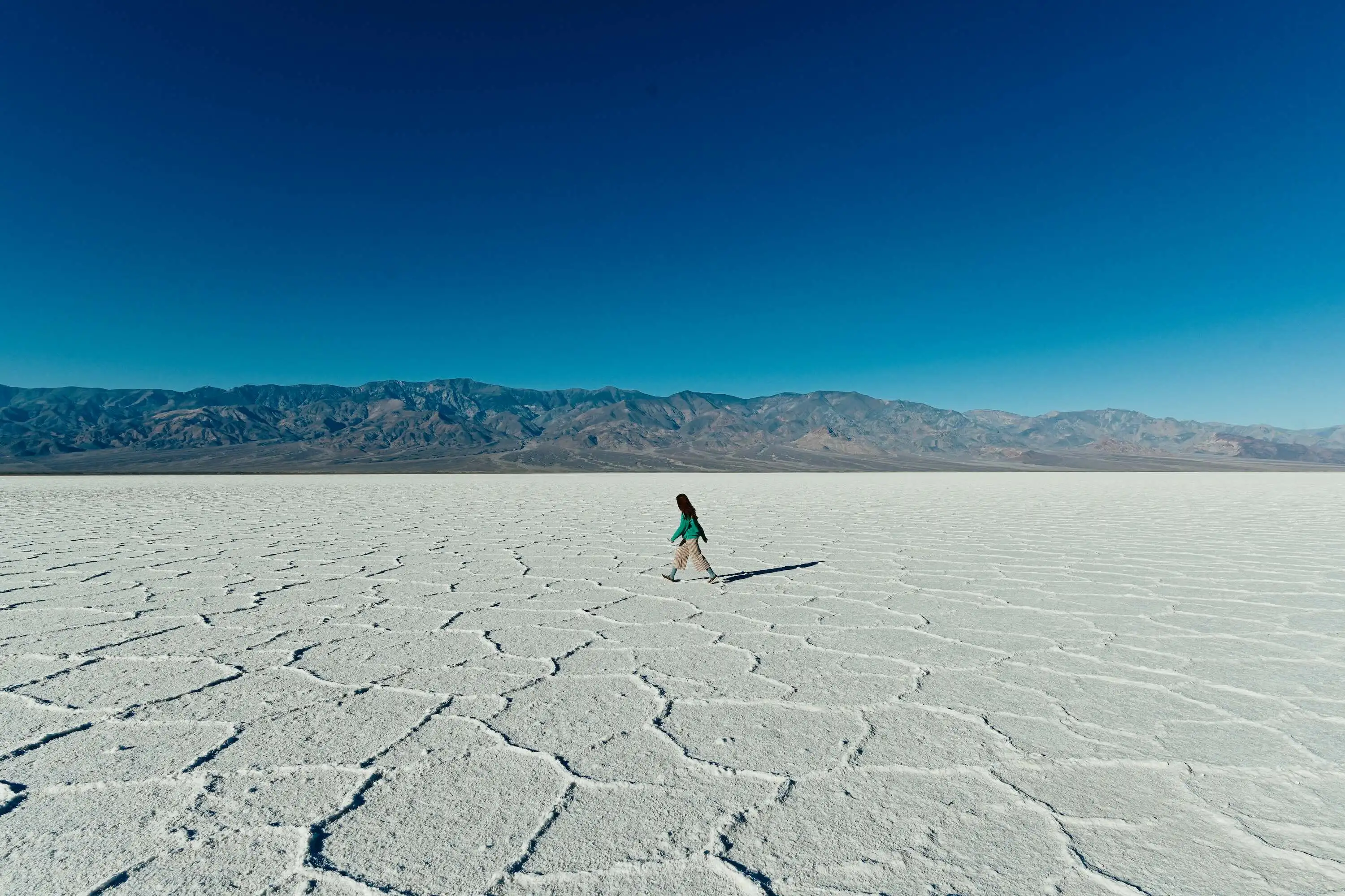 Woman walking on a salt flat.