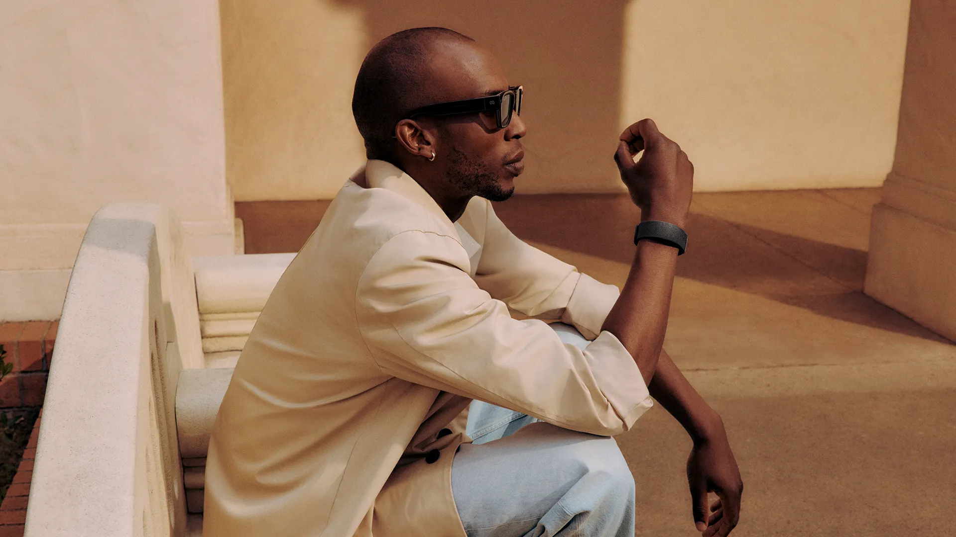 Man seated wearing Meta Ray-Ban Display glasses