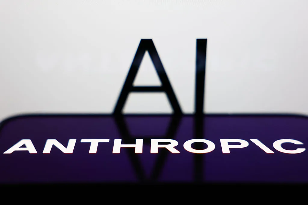 AI sign displayed on a screen and Anthropic logo displayed on a phone screen are seen in this illustration photo.